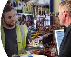 Image of two people talking at a trade counter