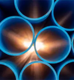 Image of the sun shining through some pipes